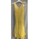 A FULL LENGTH YELLOW TULLE SLEEVELESS EVENING DRESS with 'V' neckline, circa 1940