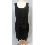 A SHORT BLACK FLAPPER DRESS, decorated throughout with jet beadwork, scoop neckline and back