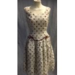 A CREAM AND LIGHT BROWN SPOTTED FLOCK NYLON PARTY DRESS, the waistline with brown satin trim,