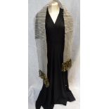 A FULL LENGTH BLACK CREPE EVENING DRESS, the shoulders and sleeves decorated with clear beadwork,