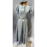 A FULL LENGTH PALE BLUE LUREX EVENING DRESS with short puff sleeves and belted waistline,