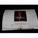 YVES ST LAURENT: A CREAM SCARF, one edge with a black and cream stripe and initialled 'YSL' in