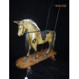 G & J LINES; A VICTORIAN PUSH-ALONG TOY HORSE, with carved wooden (hollow) body on four cast iron