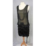 A SHORT CHIFFON FLAPPER DRESS, the skirt decorated with tasselled braiding, the bodice decorated