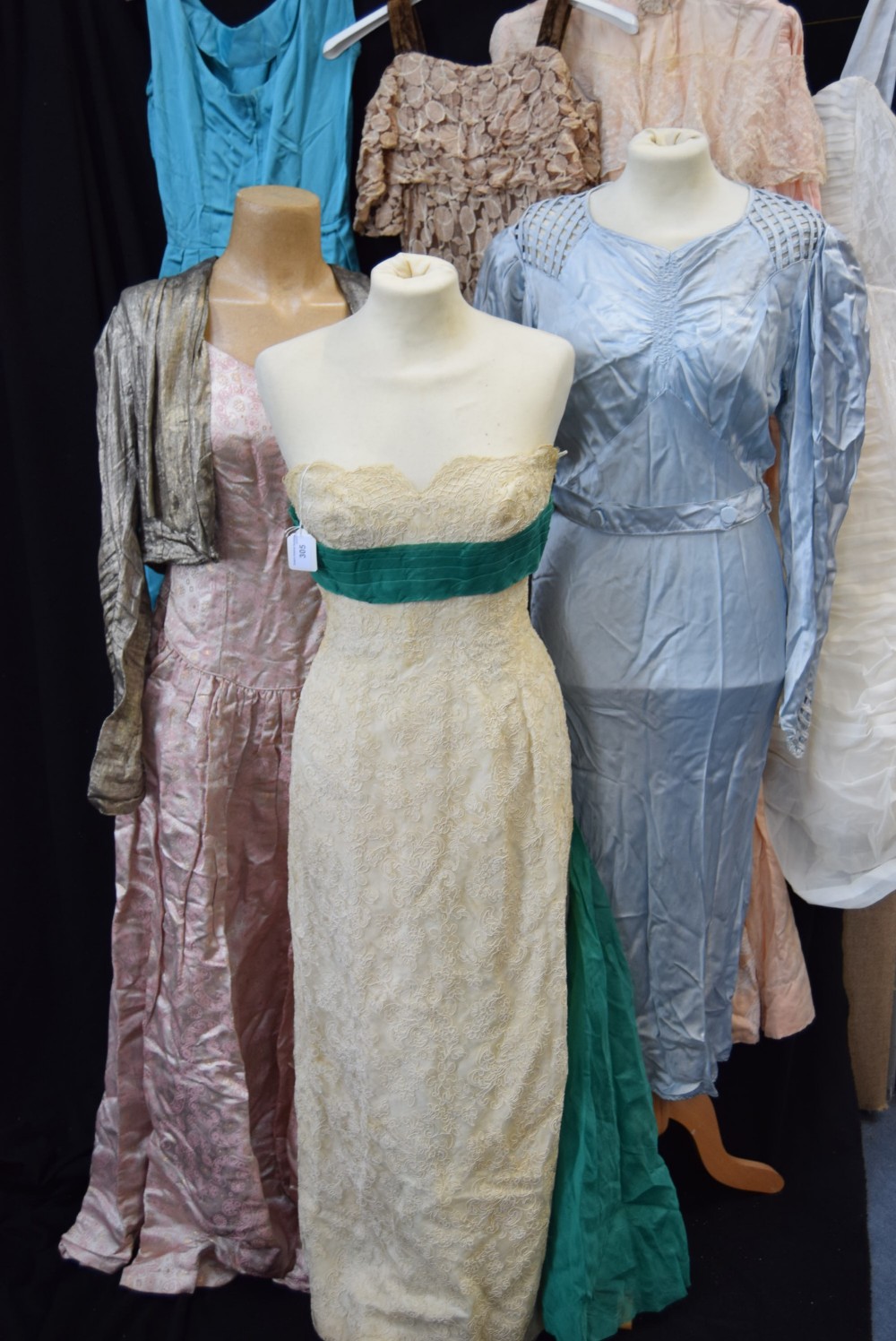 A CREAM STRAPLESS EVENING DRESS, the bodice decorated with green pleated chiffon and falling into