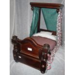 A VICTORIAN MAHOGANY HALF TESTER DOLL'S BED with later curtains and a striped ticking mattress, 23.