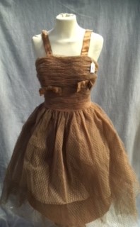 A COFFEE COLOURED TULLE PARTY DRESS, the rouched body decorated with satin bows and shoulder straps,