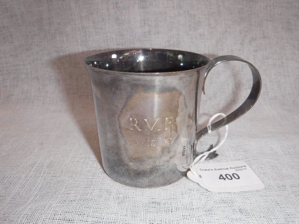 A SILVER MUG with scrolled handle, inscribed 'RVF 24.12.67' (c.207gms)
