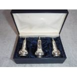 THREE SILVER PEPPER POTS in a fitted presentation case