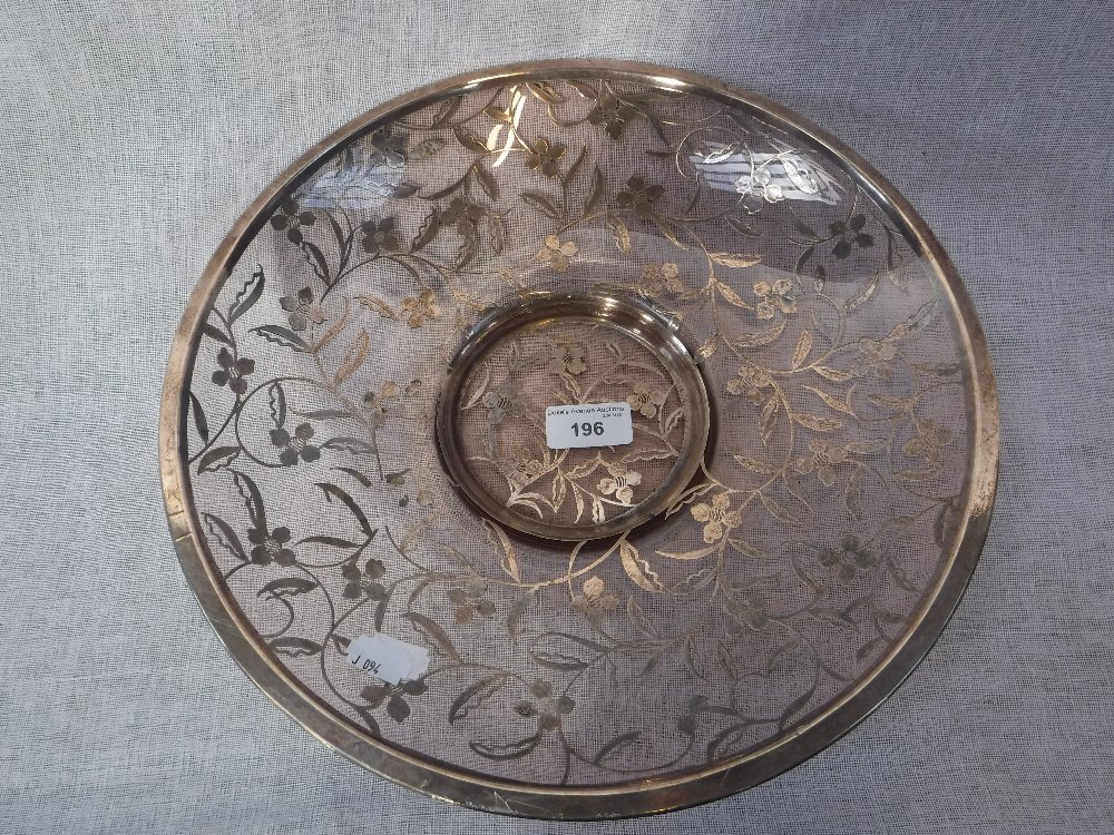 A 1930S CIRCULAR GLASS DISH, with overlaid silver floral decoration, 33 cm dia.