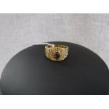 A SAPPHIRE AND DIAMOND DRESS RING, the oval cabochon sapphire channel-set to the centre of the