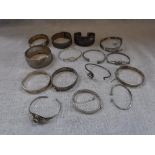 A COLLECTION OF SILVER AND WHITE METAL BANGLES