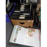 A LARGE COLLECTION OF STAMPS contained in black stamp albums