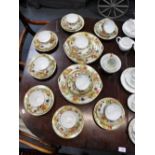 AN EARLY 20TH CENTURY CONTINENTAL TEASET, decorated with fruit within a gilt border