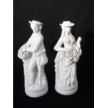 A PAIR OF VICTORIAN PARIAN FIGURES of a woman and a man collecting flowers and grapes, 34 cm high