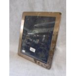 AN UNMARKED WHITE METAL PHOTOGRAPH FRAME, with easel back, 25cms x 30.5cms