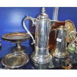 A LARGE SILVER PLATED ECCLESIASTICAL WATER JUG, 36 cm high another smaller, a collection of platters