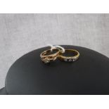 A THREE STONE DIAMOND DRESS RING, set on an 18ct yellow gold band and one other dress ring (2)