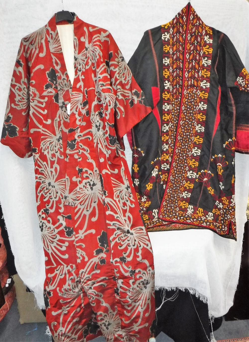 A VINTAGE KIMONO and a black housecoat with all over red, yellow and white geometric decoration (2)