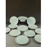 A SET OF TEN JAPANESE CELADON DISHES and two tazza, moulded with lively designs of fish amongst