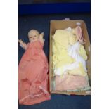 A VINTAGE PLASTIC DOLL with a collection of clothing