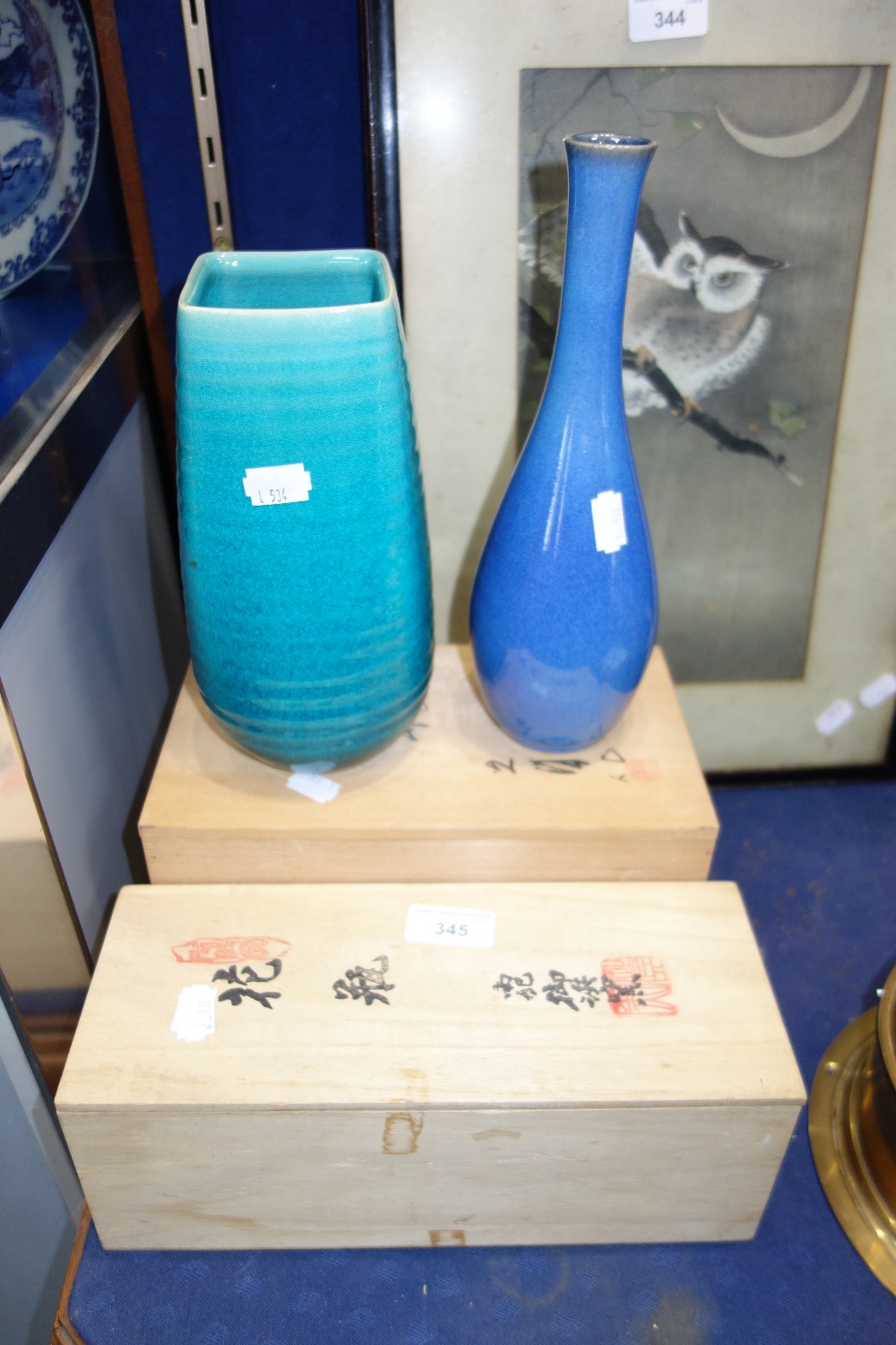 A JAPANESE MOTTLED BLUE GLAZED BOTTLE VASE and another green glazed vase, both with wooden boxes