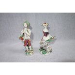 A PAIR OF 18TH CENTURY BOW FIGURES, a girl with sheep and flowers, and her companion with a basket