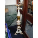 A 19TH CENTURY CHURCH PRICKET CANDLESTICK of urn form on scrolling feet. painted white with gilt