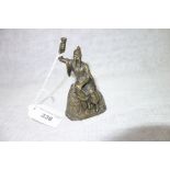 AN ORIENTAL BRASS BELL, the handle in the form of a wise man, 9 cm high (clapper missing)