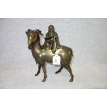 AN ORIENTAL PATINATED BRASS STUDY OF A GOAT with a wise man on his back, 24 cm high