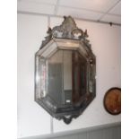 A 19TH CENTURY VENETIAN PALAZZO MIRROR of octagonal form with scrolling crest, 73 cm wide x 122 cm