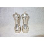 A PAIR OF SILVER SALT AND PEPPER GRINDERS