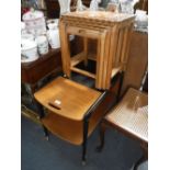 A 1960'S TEAK AND EBONISED TROLLEY with extending flap, and a nest of tables