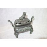 A CHINESE BRONZE TWO HANDLED CENSER with a lion/dog finial. Xuan De stamp to the base, 16 cm high (