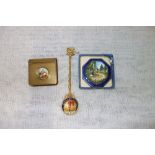 A BRASS STAMP HOLDER, the hinged lid with an enamelled inset, decorated with classical figures and a
