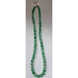 A 'JADE' BEADED NECKLACE, 63 cm long