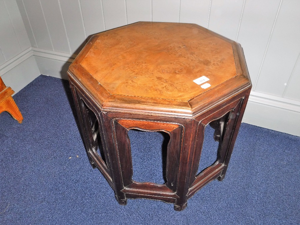 A CHINESE HARDWOOD OCTAGONAL LOW TABLE with burwood top, 49" wide