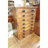 A VICTORIAN STAINED PINE COLLECTOR'S CHEST OF EIGHT DRAWERS with ebonised knobs, 66 cm high x 48