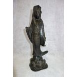 AN ORIENTAL PATINATED BRONZE STUDY OF A WOMAN in traditional robes, 27.5 cm high (both hands