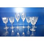A PAIR OF LALIQUE WINE GLASSES, decorated with frosted angels, 20.5 cm high and five Waterford