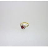 A 'RUBY' AND DIAMOND DRESS RING, on an 18ct yellow gold shank, ring size P