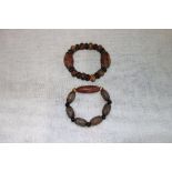 A TIBETAN AGATE '9-EYED' BRACELET and another similar