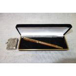 A STERLING SILVER VESTA CASE, embossed both sides with golf players and a boxed ballpoint pen with