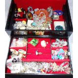 A COLLECTION OF COSTUME JEWELLERY in a fitted black and gilt jewellery box