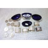 A COLLECTION OF SILVER NAPKIN RINGS, silver salts and a small collection of coins