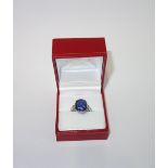 A BLUE STONE DRESS RING on a white gold shank, ring size M