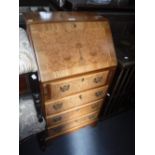 A REPRODUCTION BURR WALNUT BUREAU of small proportions 52 cm wide