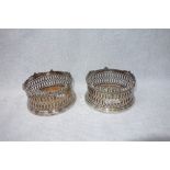 A PAIR OF 19TH CENTURY SILVER PLATED BOTTLE HOLDERS