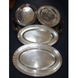 A SILVER PLATED OVAL MEAT DISH, others similar and a pair of 19th century plated candlesticks