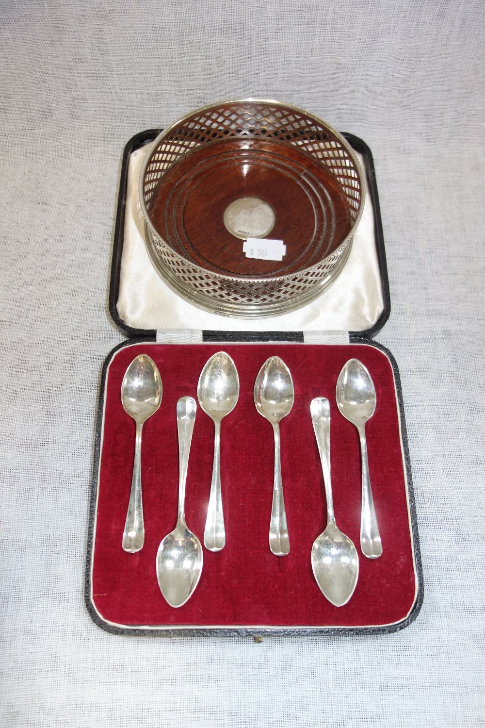 A SET OF SIX SILVER TEASPOONS in a fitted presentation case and a silver coaster with wooden base
